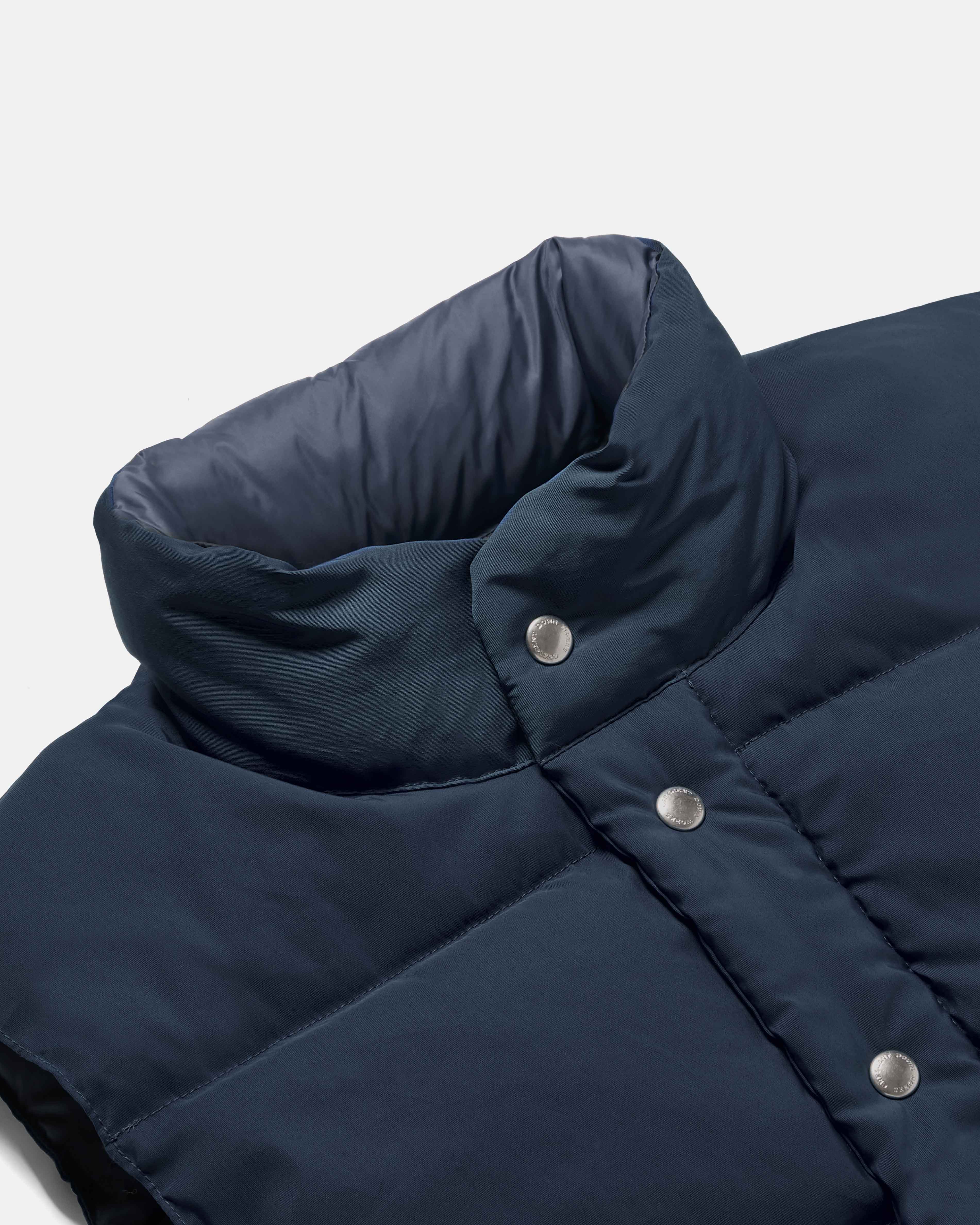 Close-up of snap front on navy Crescent cotton nylon vest
