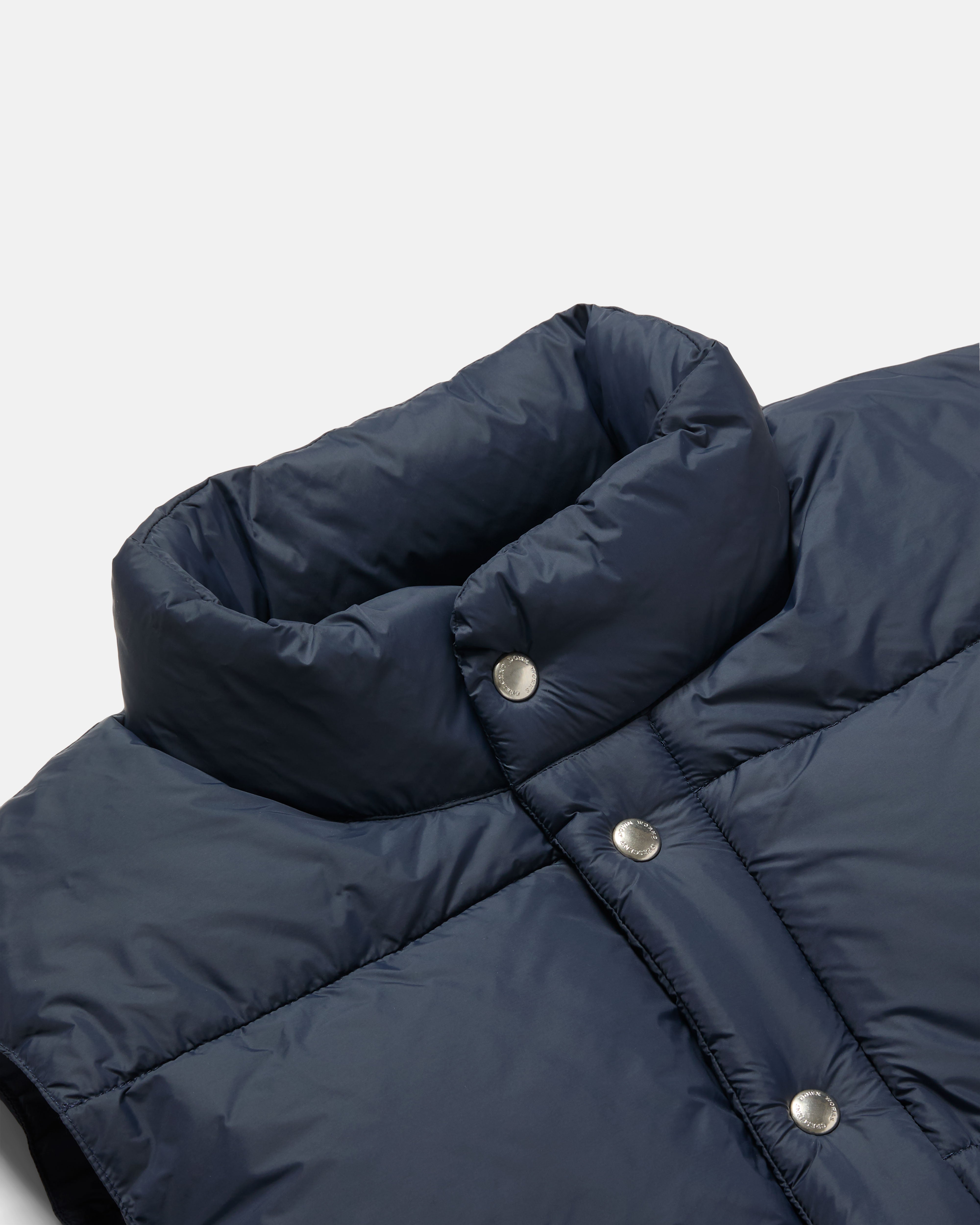 Close-up of snap front on navy Crescent nylon vest