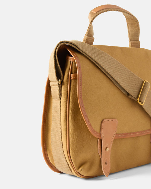 Close-up of leather trim and stitching on sandstone Beorma Morar messenger bag