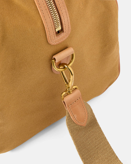 Close-up of stitching and leather trim on sandstone Beorma Ness weekend bag