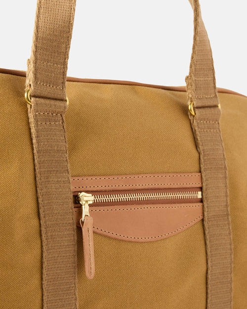 Close-up of leather handles on sandstone Beorma Ness weekend bag