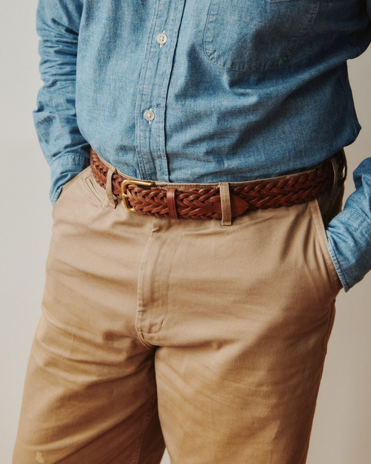 Lifestyle view of Beorma brown plaited leather belt with Kamakura button down chambray shirt