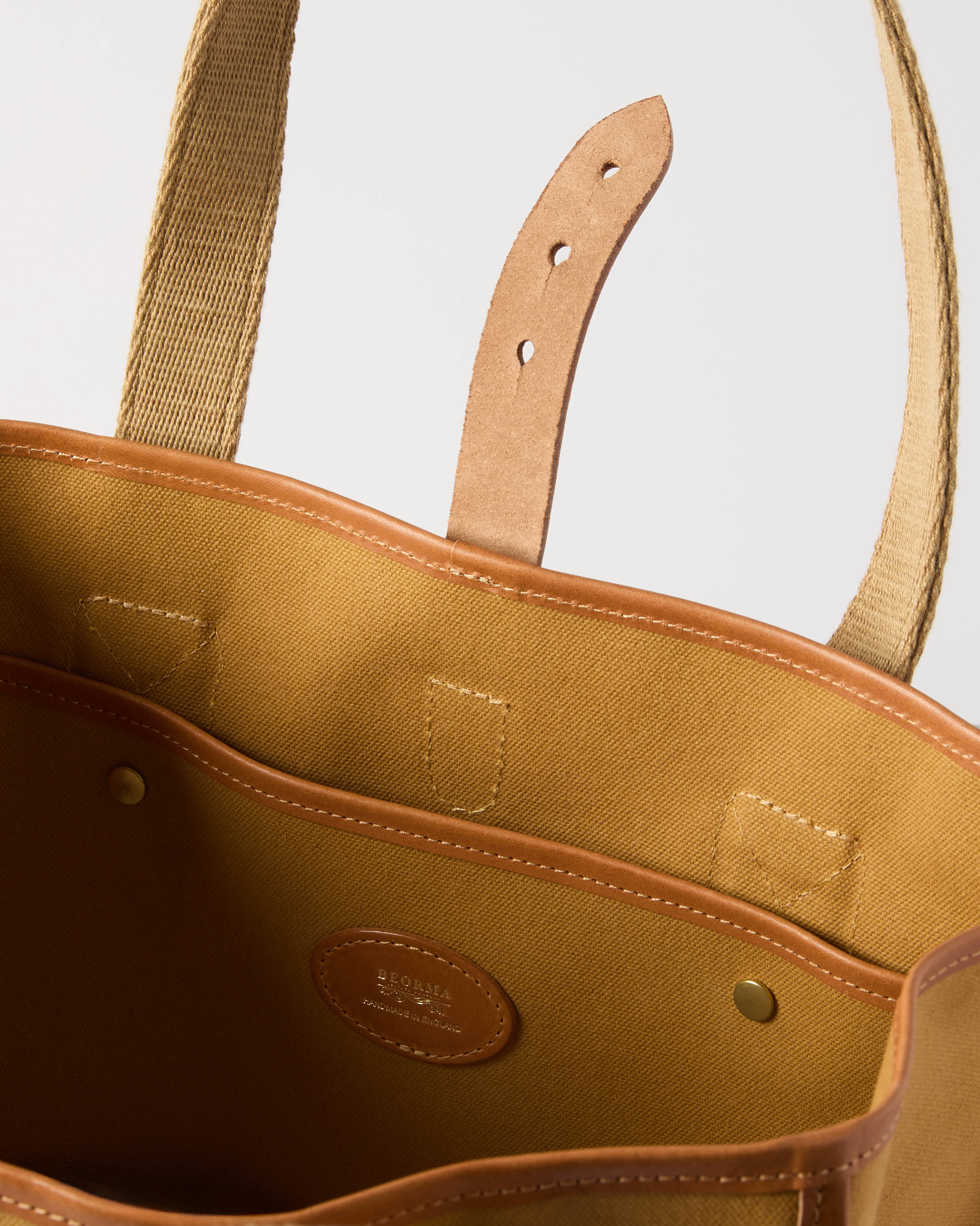 Open view of sandstone Beorma Tay tote bag showing spacious interior and pocket