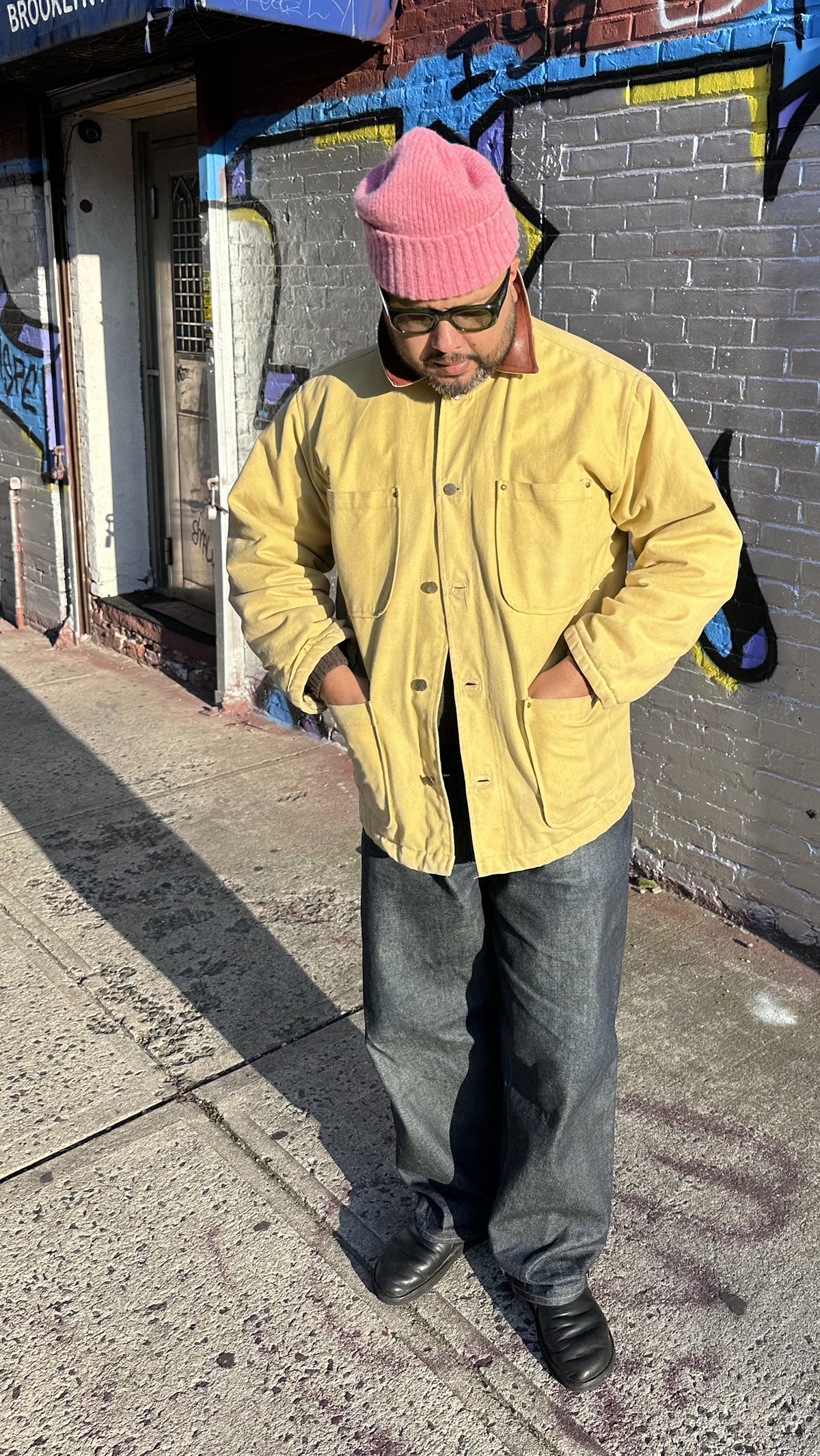 Lifestyle view of Brandon Mahler wearing yellow chore jacket and pink beanie in the Something Old Something New series