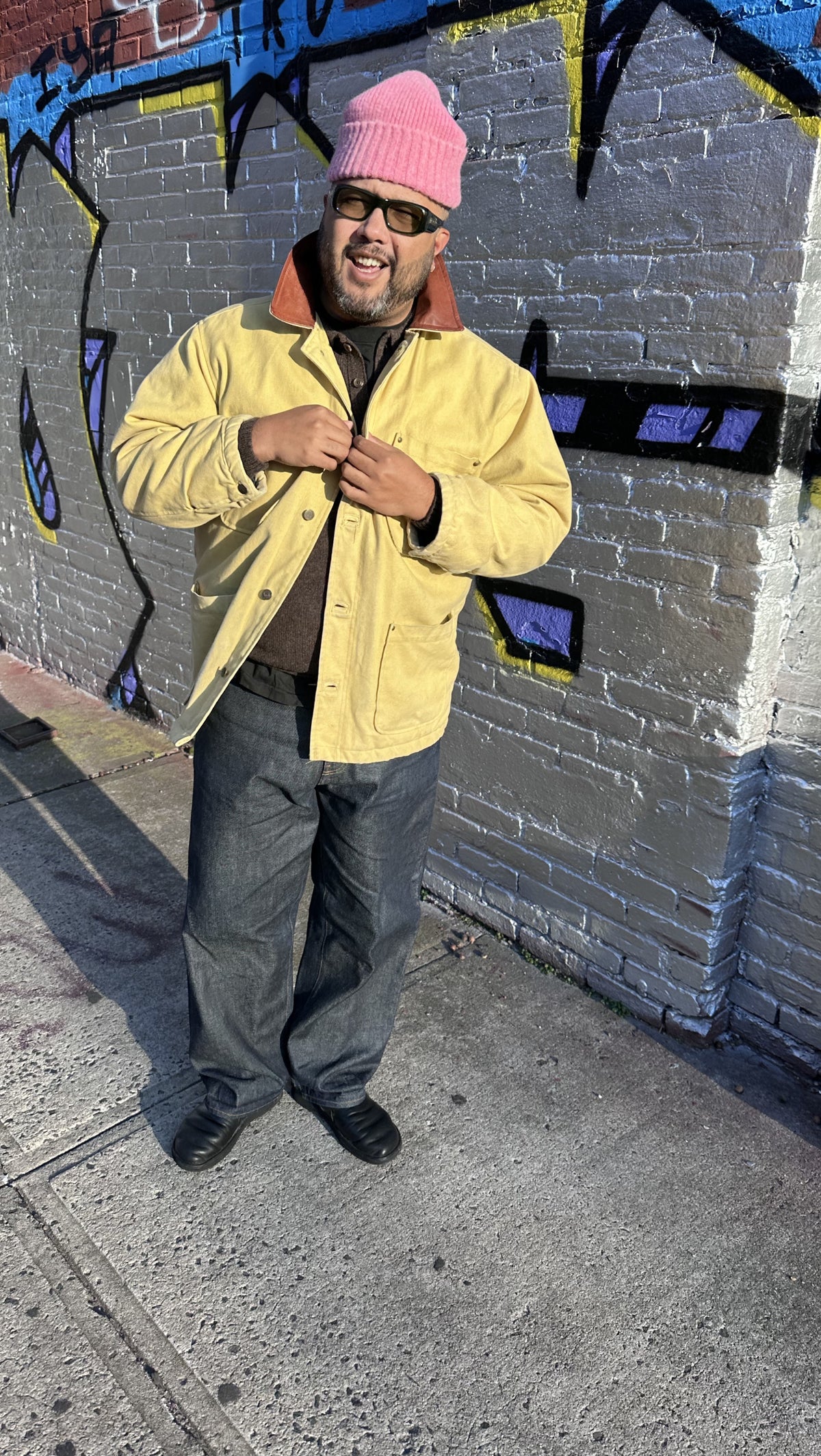 Lifestyle view of Brandon Mahler wearing yellow chore jacket and pink beanie in the Something Old Something New series