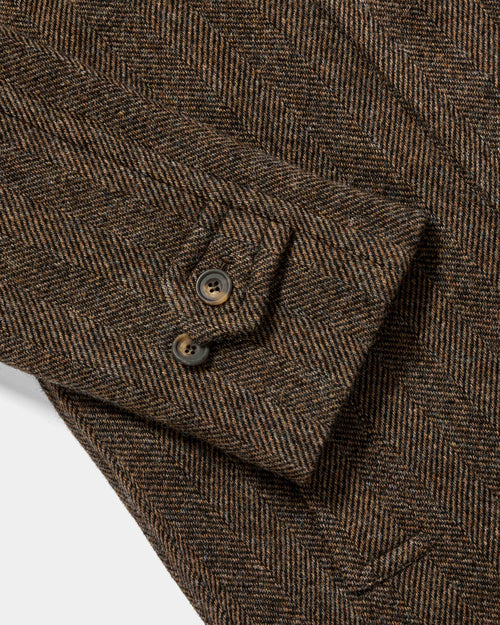 Close-up of cuff tab and button detail on brown Chrysalis Kensington coat
