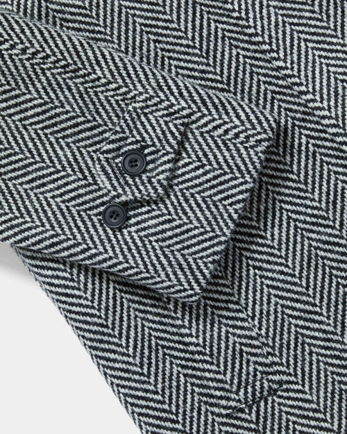 Close-up of cuff tab and button detail on herringbone Chrysalis Kensington coat