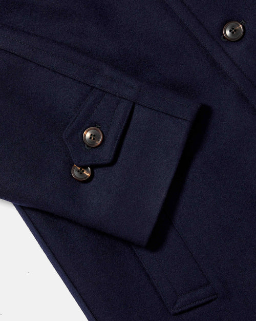 Close-up of cuff tab and button detail on navy Chrysalis Kensington coat