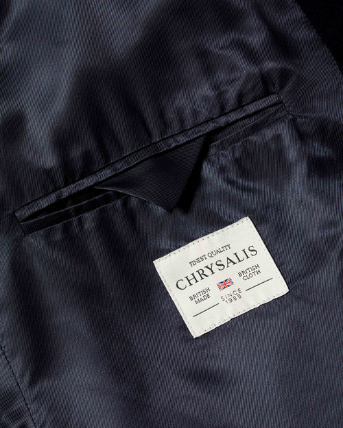 Close-up of interior pocket, lining and brand label on navy Chrysalis Kensington coat