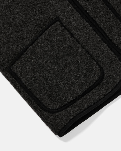Close-up of patch pocket detail on black Coldbreaker wool gilet