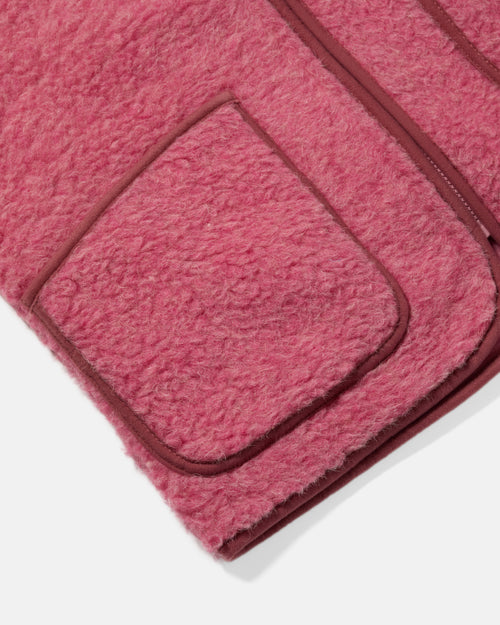 Close-up of patch pocket detail on pink Coldbreaker wool gilet
