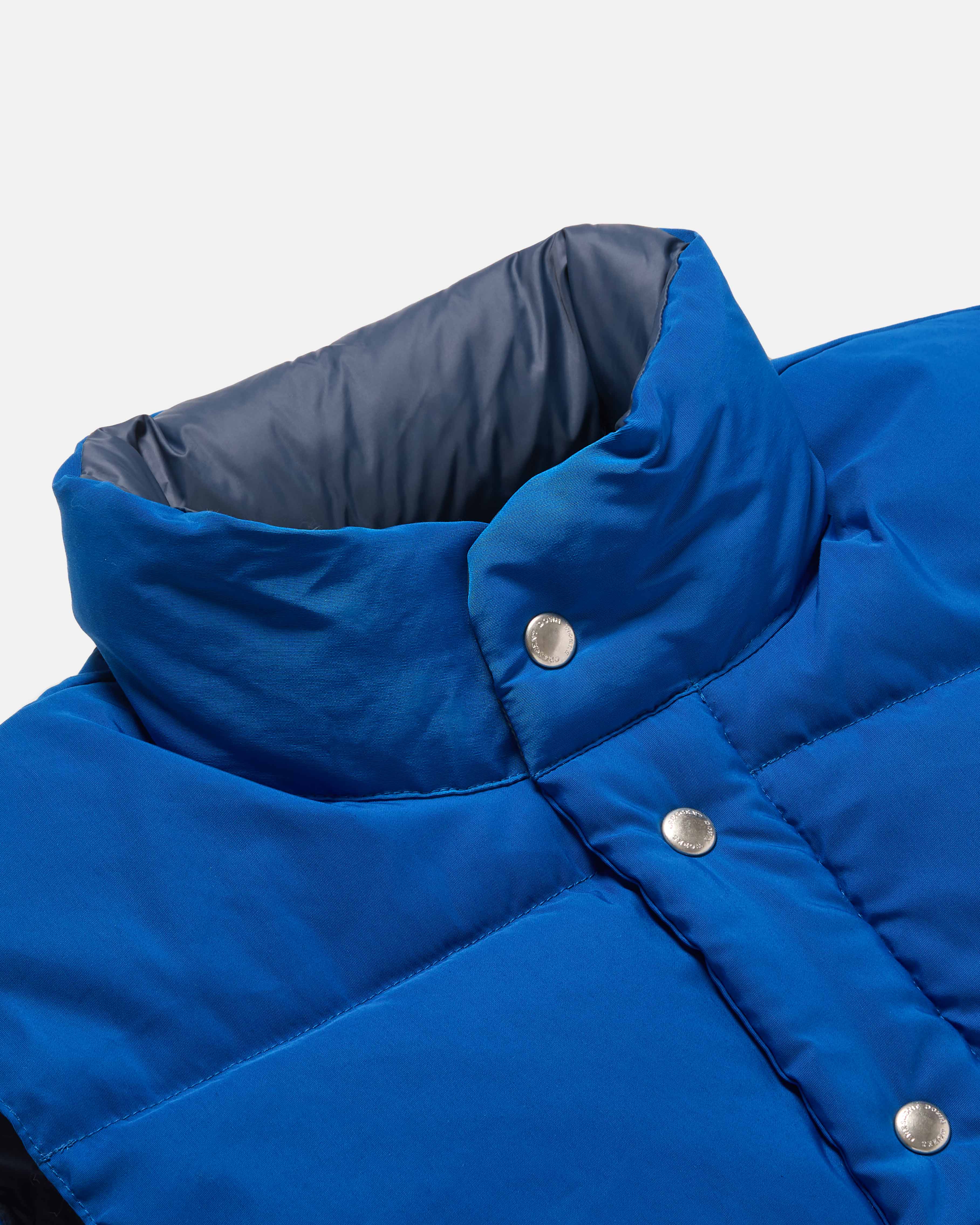 Close-up of snap front on royal blue Crescent cotton nylon vest