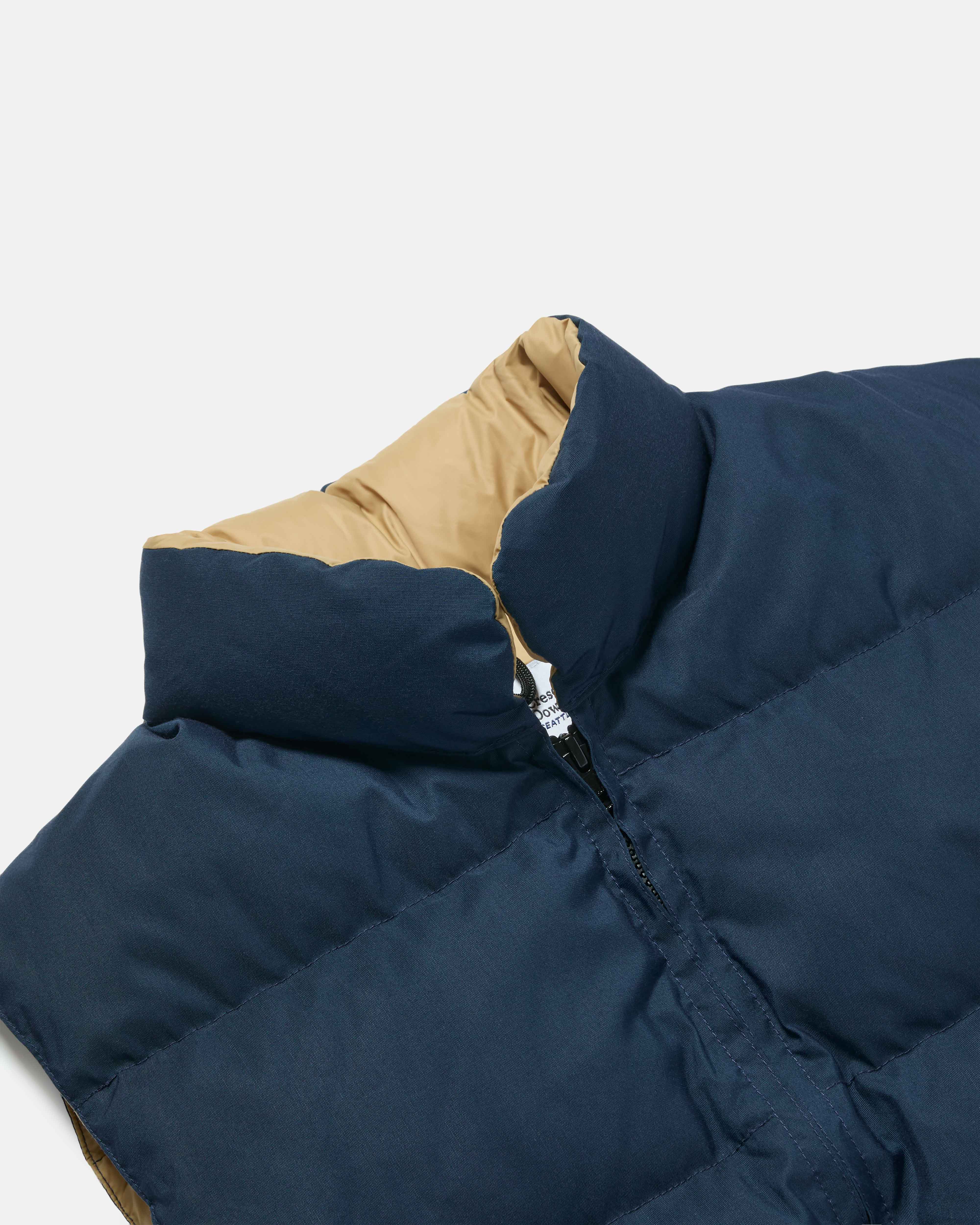 Close-up of snap front on navy Crescent nylon vest
