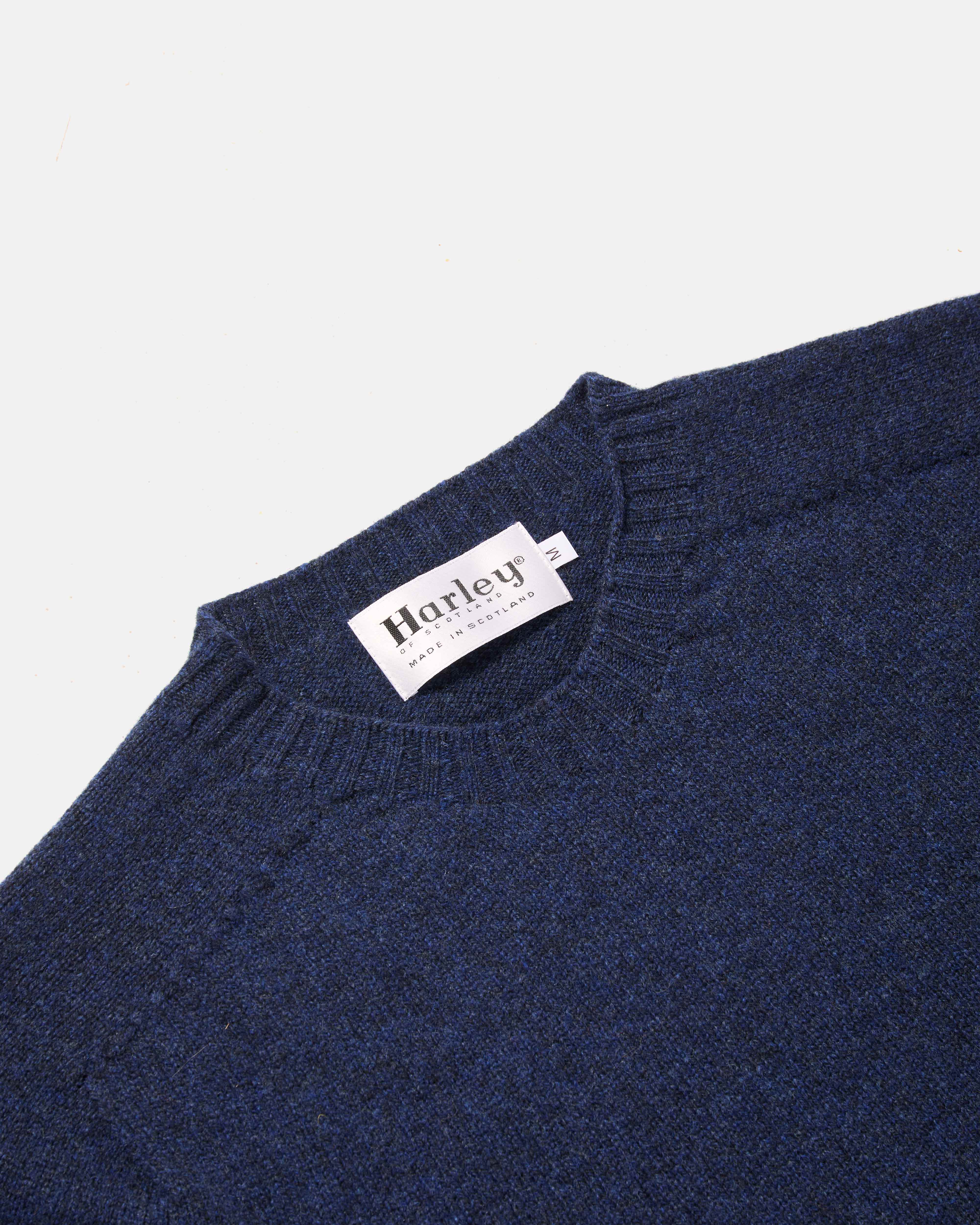 Close-up of crew neck collar detail on navy Harley Superfine Lambswool Crew Neck