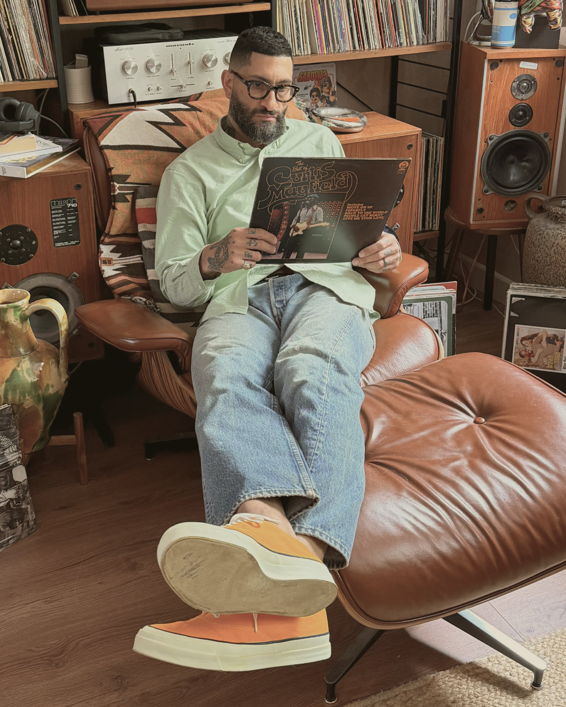 Lifestyle view of Kamakura Miles Davis green Oxford button-down shirt styled with denim jeans and slip-on shoes