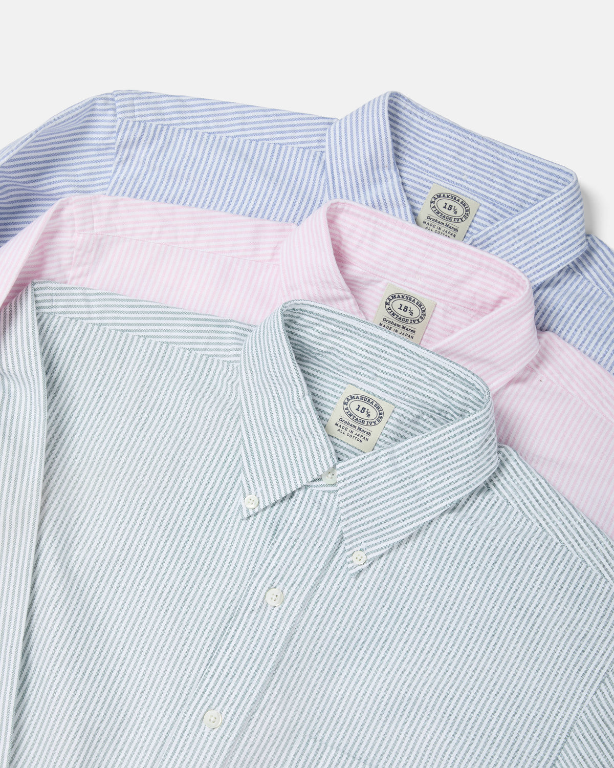 Flat lay of Kamakura Vintage Ivy university stripe Oxford button-down shirts in green, pink and blue