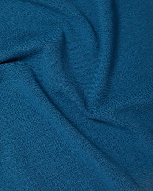 Close-up of Ice Cotton knit fabric on blue Mooncastle polo shirt