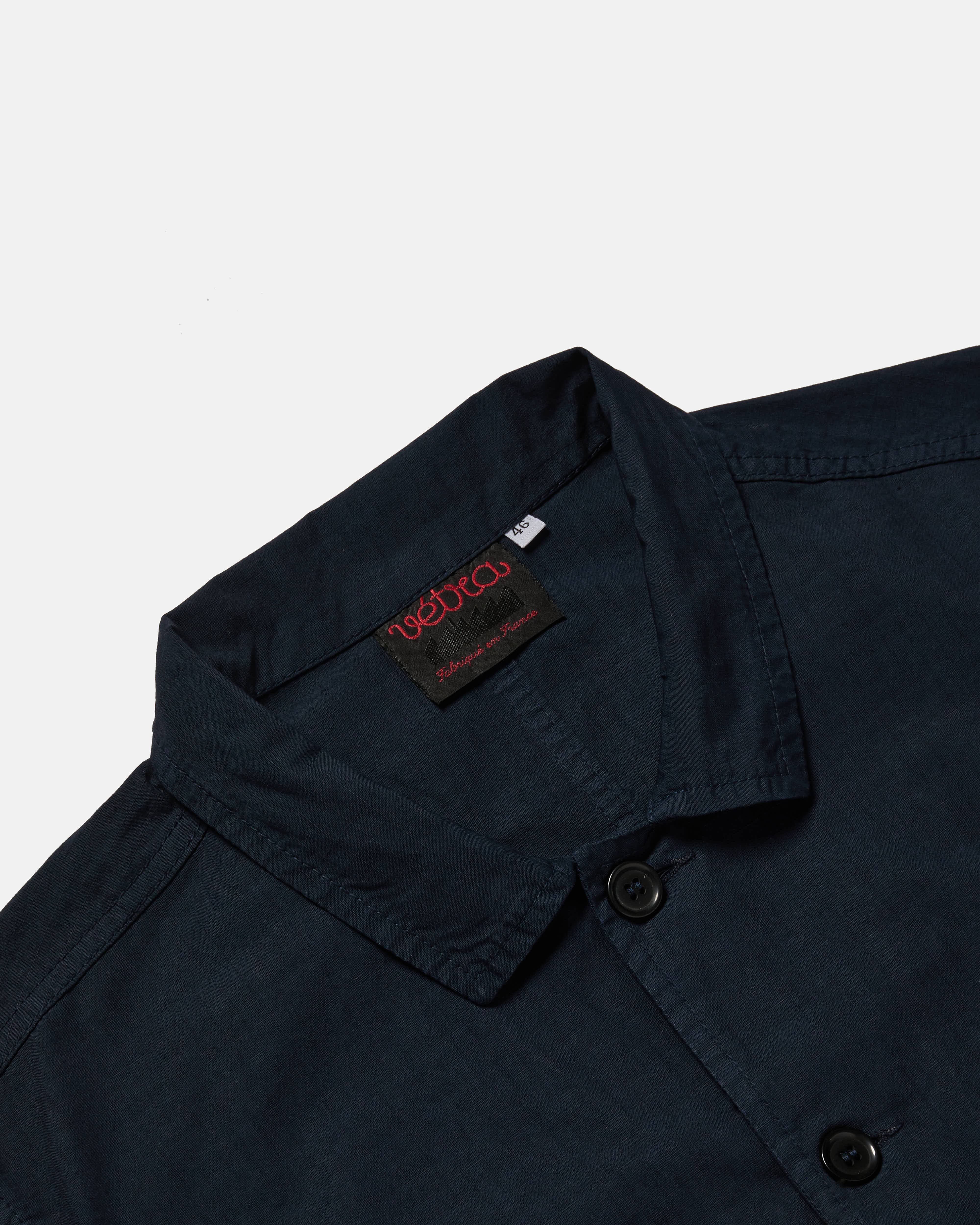 Close-up of button front on navy Vetra ripstop jacket