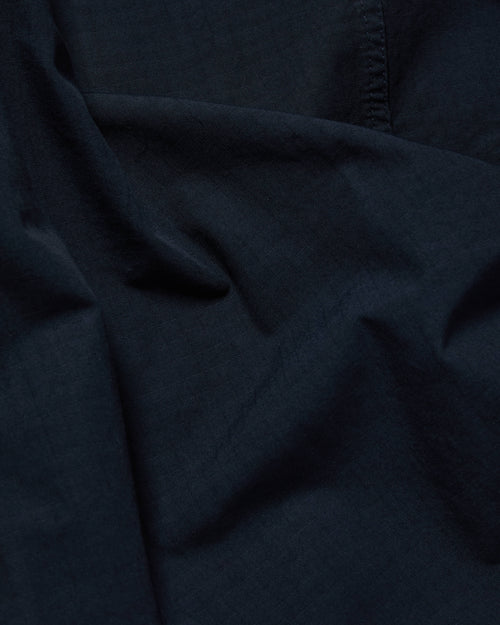 Close-up of ripstop cotton fabric on navy Vetra bomber jacket