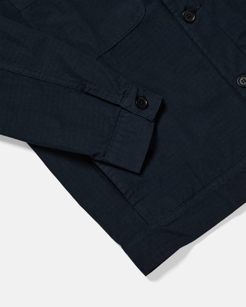 Close-up of pocket detail on navy Vetra bomber jacket