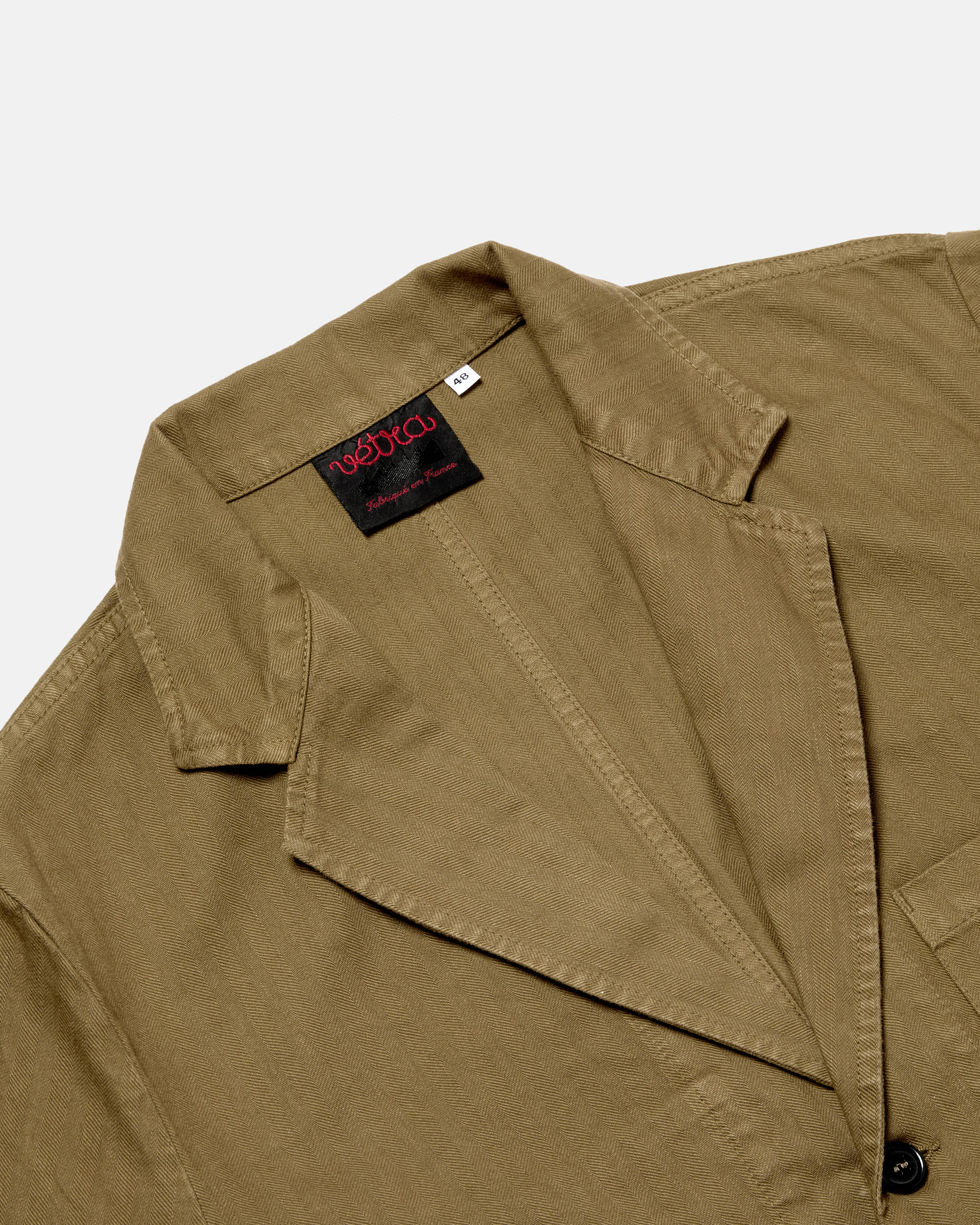 Close-up of stitching and construction on olive Vetra workwear blazer